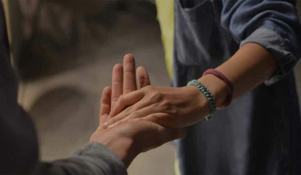Hands holding 700 - Helping or Enabling? Understanding Boundaries in Addiction Support