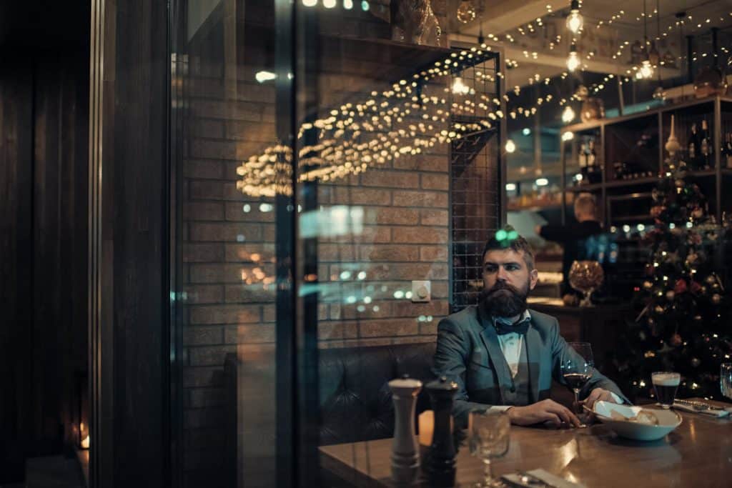 a man is sitting alone during Christmas in a cafe