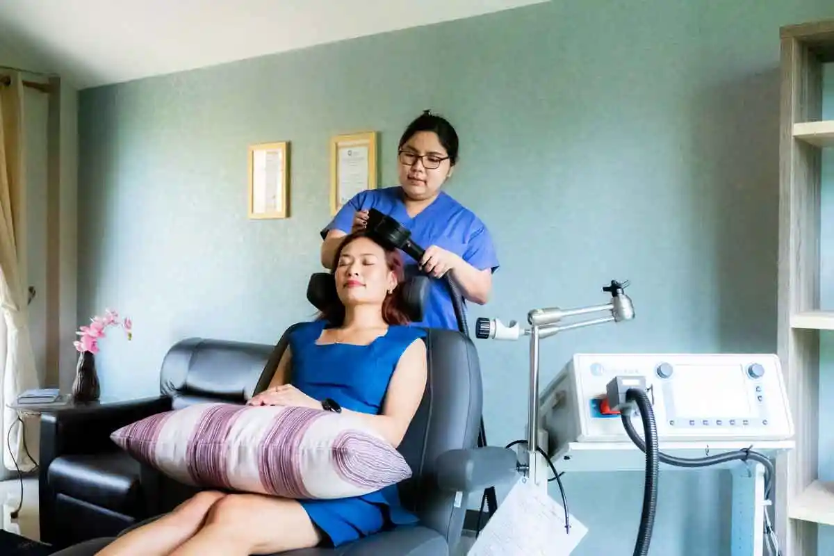 A female client receving TMS therapy at The Dawn.