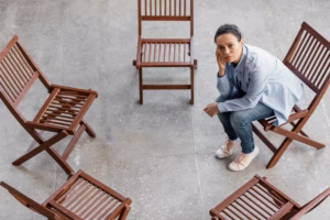 Full shot sad woman sitting on chair